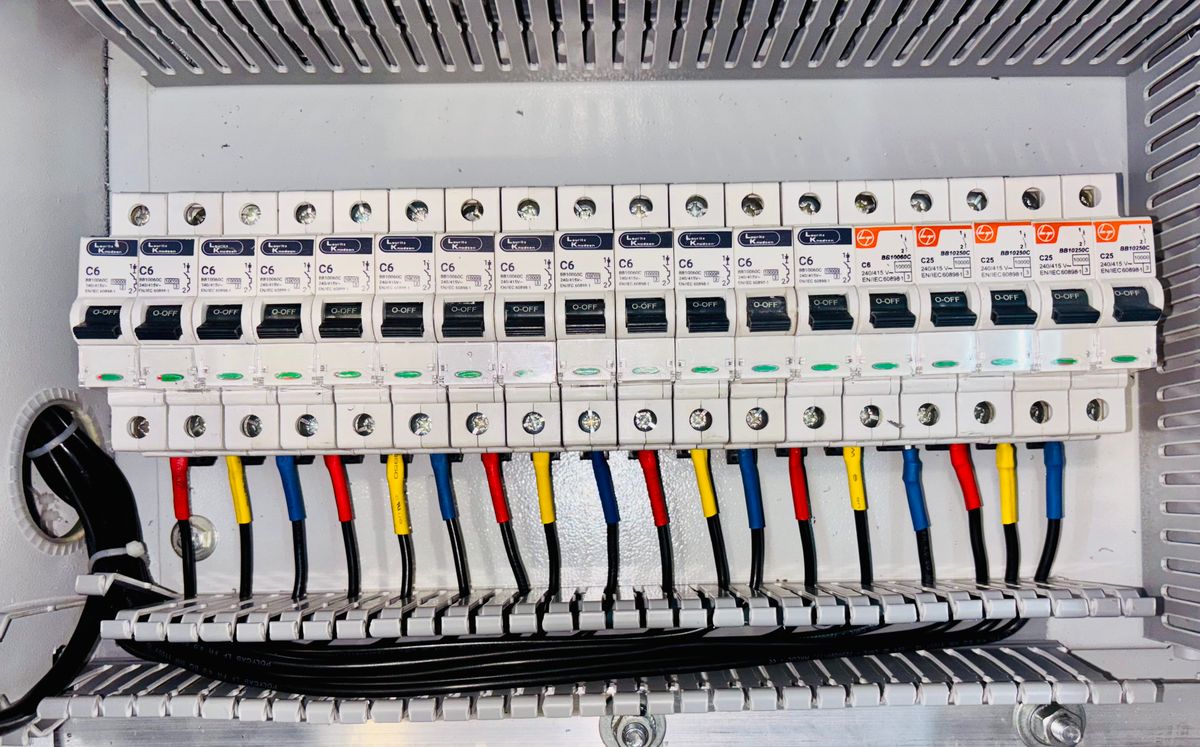 Close-up of circuit breakers and wiring inside an electrical panel